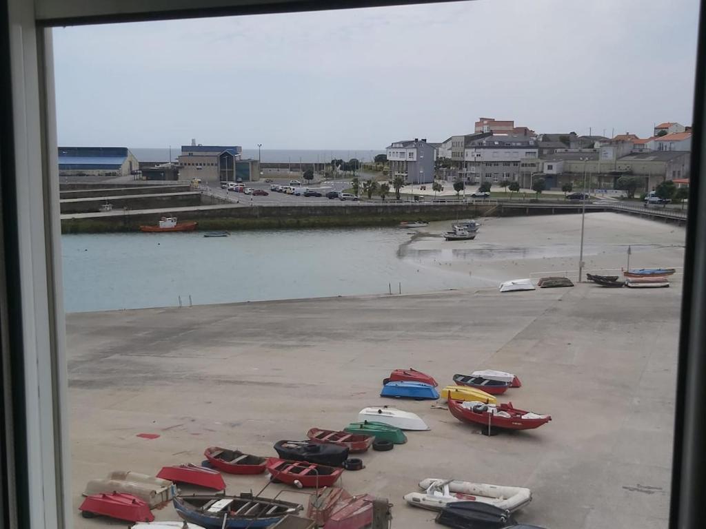 a group of boats parked in a parking lot at Apartamento Playa Robalo-Aguiño in Aguiño