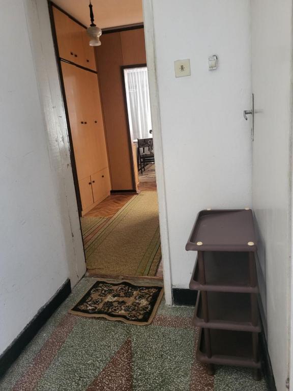a hallway with a stair case and a mirror at Апартамент Стоянови in Primorsko