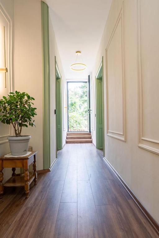 an empty hallway with a potted plant on a table at Harmonia Apartments in Bitola