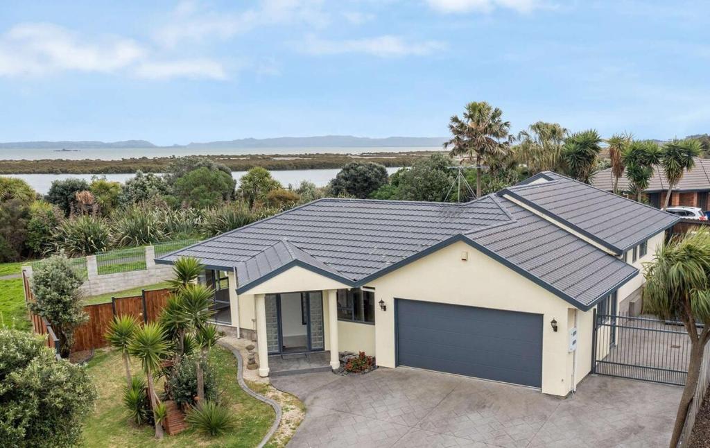 an aerial view of a house with a garage at Stunning Sea View Home Very near to AKL Airport in Auckland