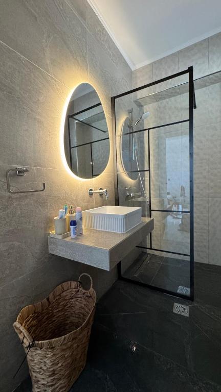 a bathroom with a sink and a mirror at Ioli's Apartments Zante in Alykes