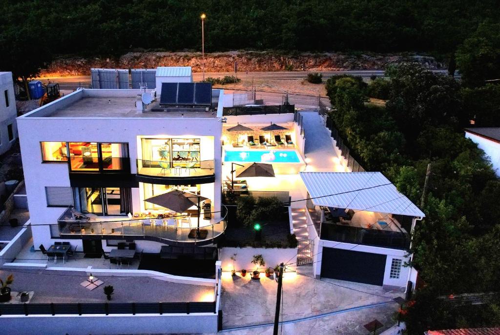an aerial view of a large white house at night at Villa Sanys Selce in Selce