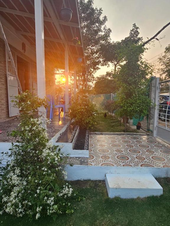 a house with a stone walkway in the front yard at Sreevara Farms in Hosūr