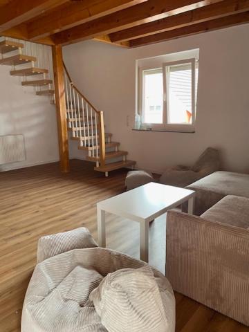 a living room with a couch and a table at Ferienwohnung Sonnenschein in Kappel-Grafenhausen