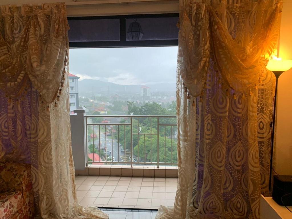 a room with a large window with a view at Urban bloom stays in Kuala Lumpur