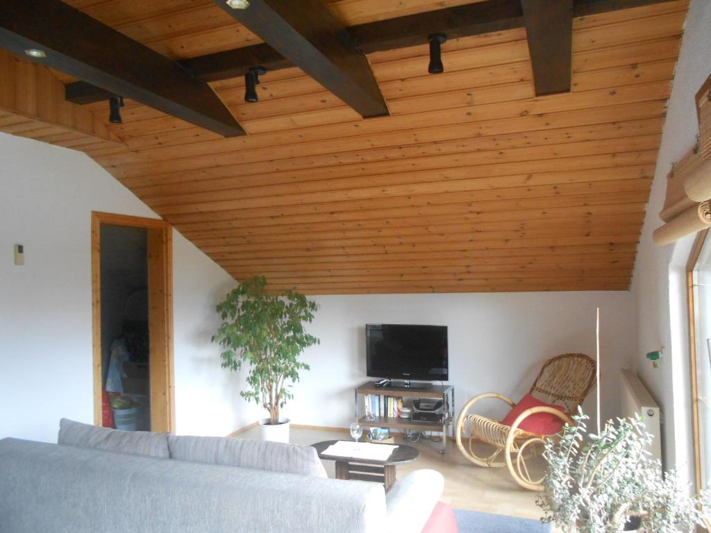 a living room with a couch and a tv at Ferienwohnung Jutta in Höchst