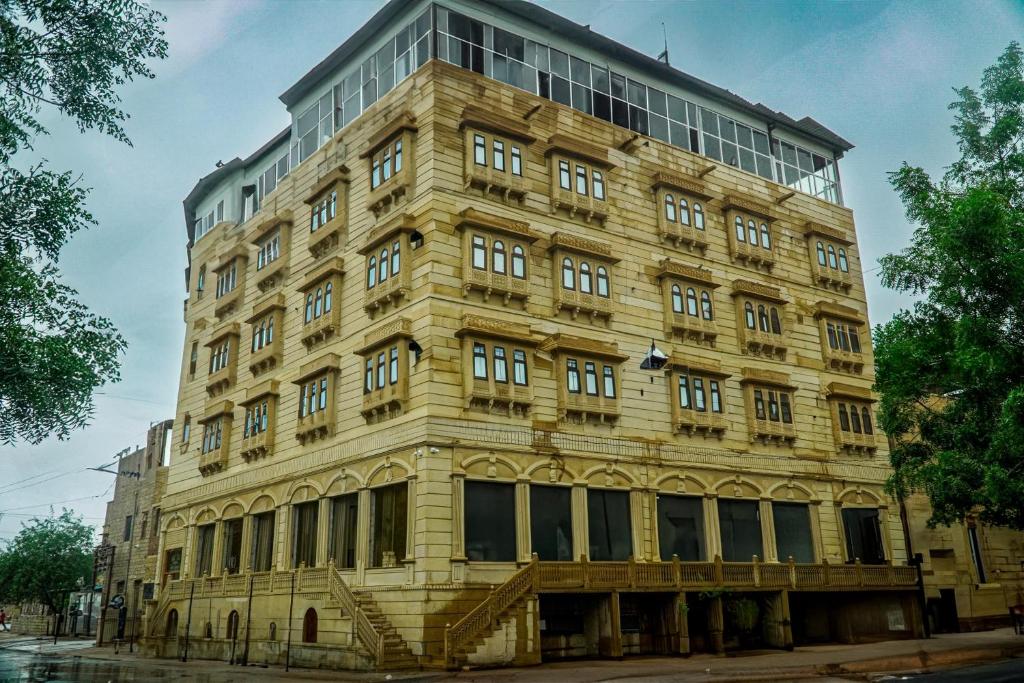 a large stone building with a lot of windows at Hotel Jaisal Inn - Pure Veg in Jaisalmer