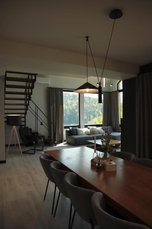 a living room with a dining room table and chairs at INOclub in Tatariv