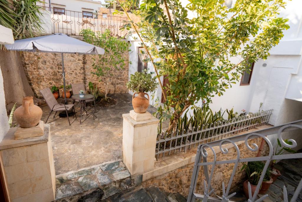 an outdoor patio with a table and an umbrella at Rethymno Dome Garden in Rethymno