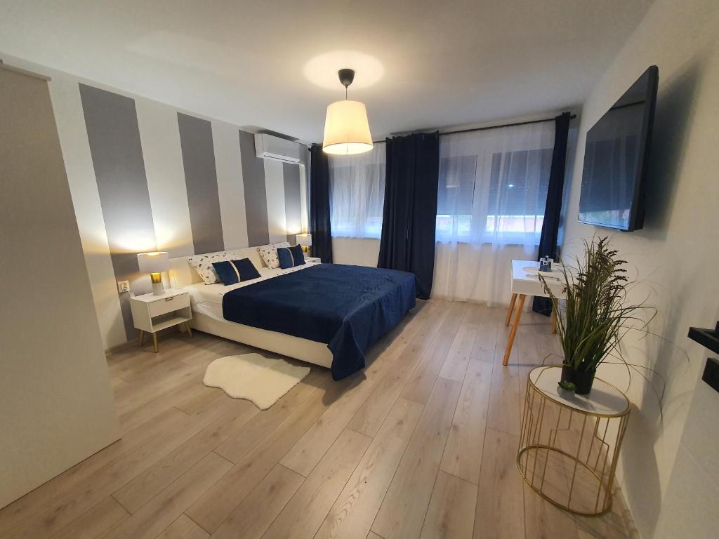 a bedroom with a bed with a blue bedspread at Apartman Jež 4 De Lux - self check in, free parking in Karlovac