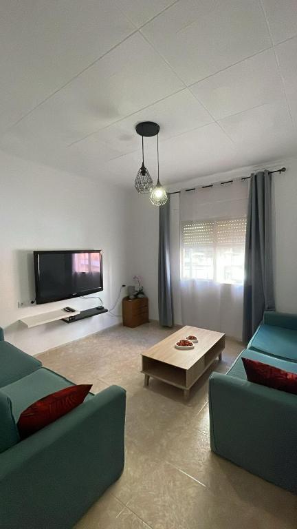 a living room with two couches and a tv at La perle de Benicarló 1 in Benicarló