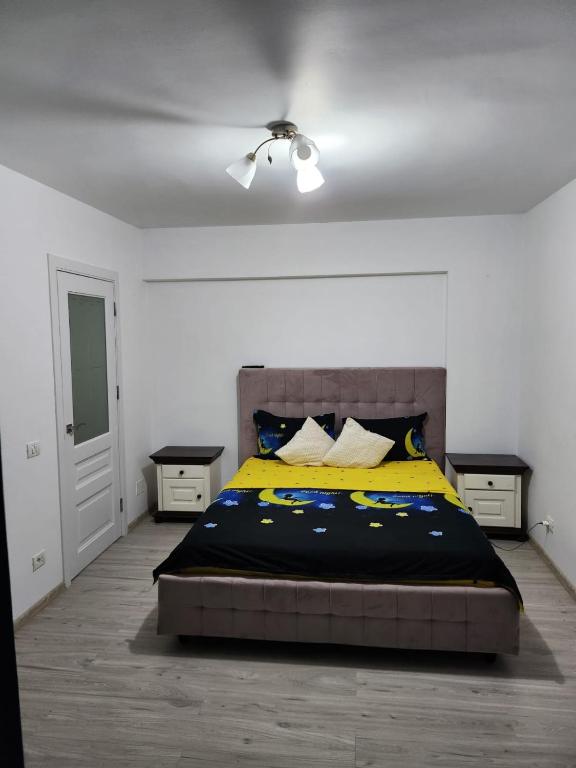 a bedroom with a bed and two night stands at Gara De Nord 3 Rooms Apartment Superb City View in Bucharest