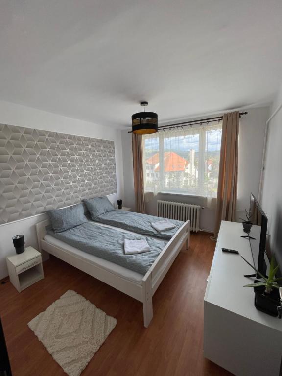 a bedroom with a large bed and a window at The Home in Gheorgheni