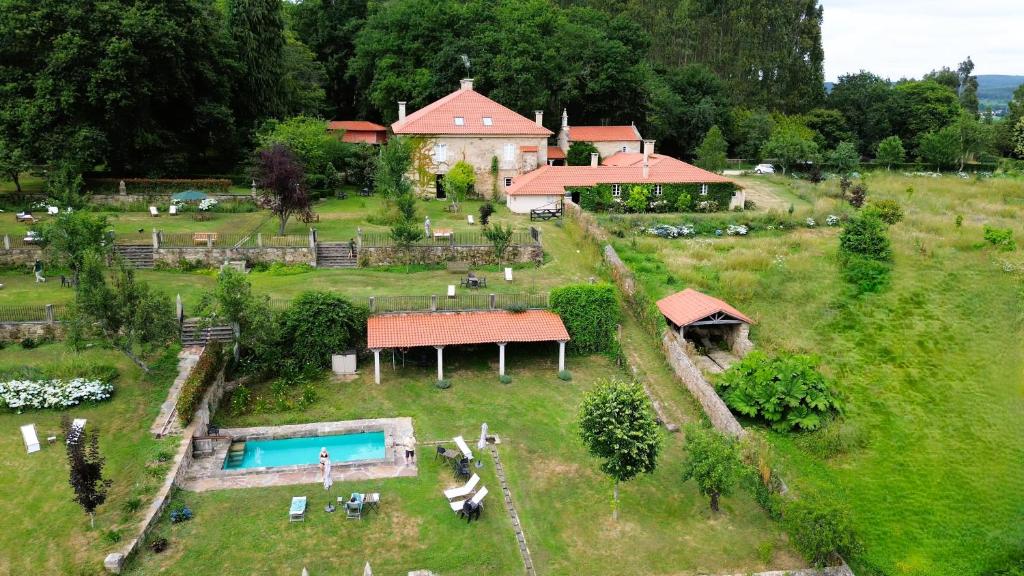 an aerial view of a house with a yard with a pool at Hotel Pazo de Bieite in Boimorto