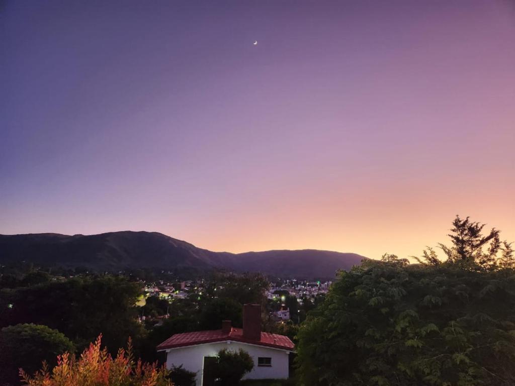 a view of a city at sunset at Refugio de Luz in La Falda