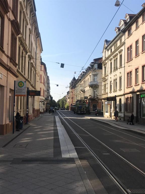 an empty street in a city with buildings at TOP Location Apartment Heidelberg Centrum near Hauptbahnhof, Bismarckplatz, Schloss in Heidelberg