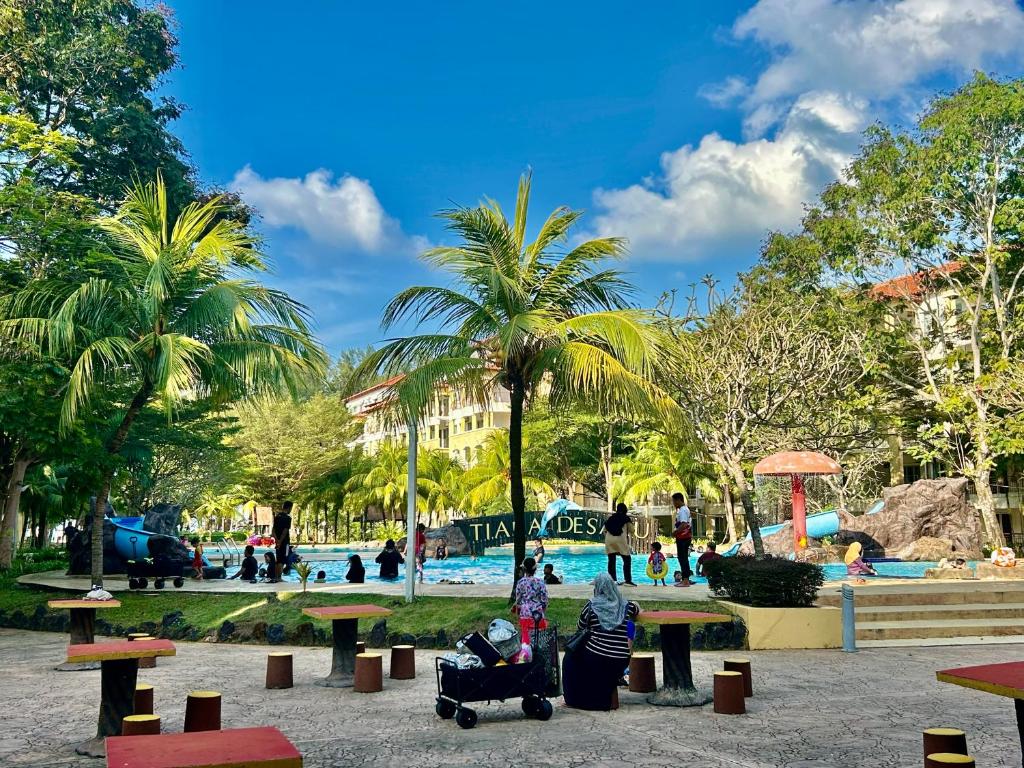 a group of people in a park with a playground at Tiara Homestay Desaru - Nature view in Bandar Penawar