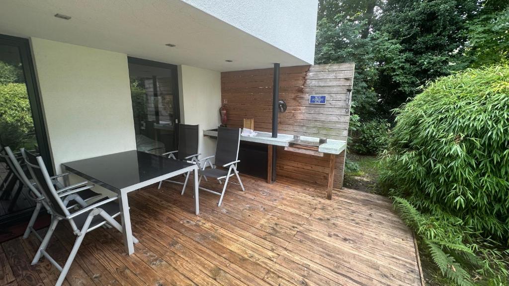 a patio with a table and chairs on a deck at FREIraum14 in Oldenburg