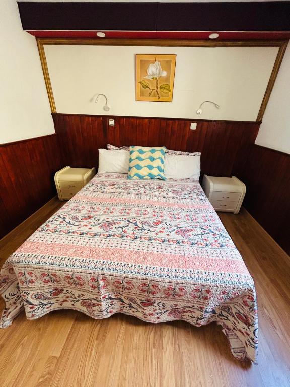a bedroom with a bed with a quilt on it at Neptuno 12 in Caleta De Fuste