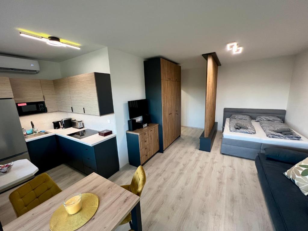 a small room with a bed and a table in it at Eternity Apartment in Štúrovo