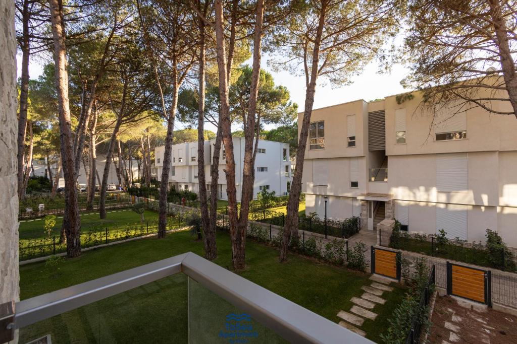 a view of the courtyard of a building with trees at ToSea Apartment by Melia in Lalzit Bay