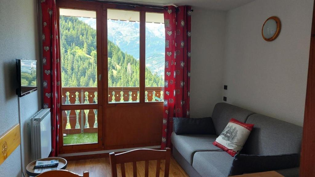 un salon avec un canapé et une grande fenêtre dans l'établissement Résidence Chaviere - CHAVIERE - CHAV38 MAE-3091, à Modane