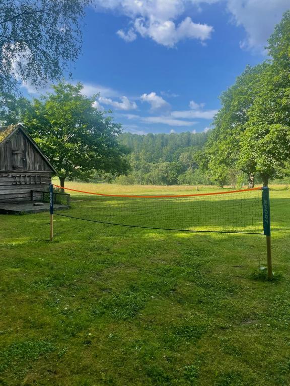 a field with a barn and a fence at Ventlejas in Strakši