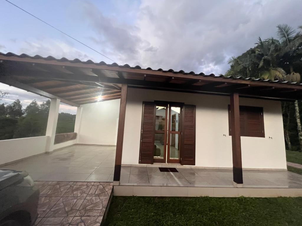 a small white house with brown shutters at Casa da Figueira in Louro Müller
