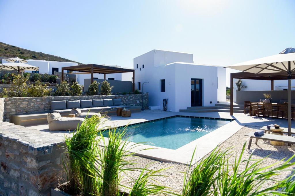 a villa with a swimming pool and a house at ANOTERRA VILLAS -Auralis in Ambelas