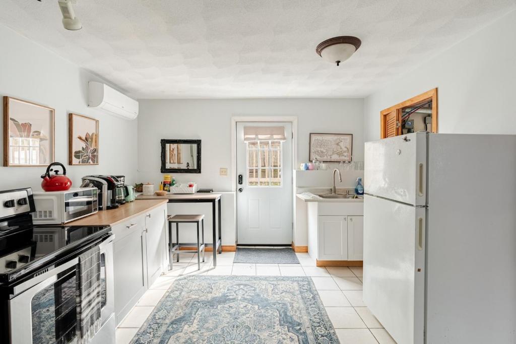 a kitchen with white appliances and a white refrigerator at Properties by Menjivar in Beverly