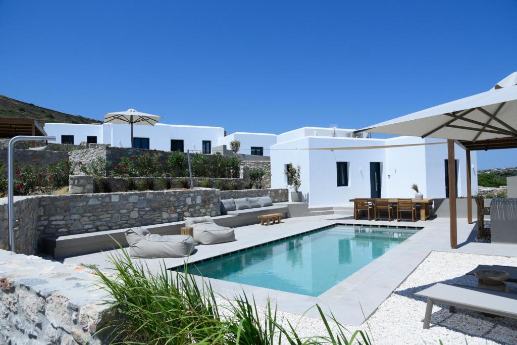 a villa with a swimming pool and a patio at ANOTERRA VILLAS -Anemone in Ambelas