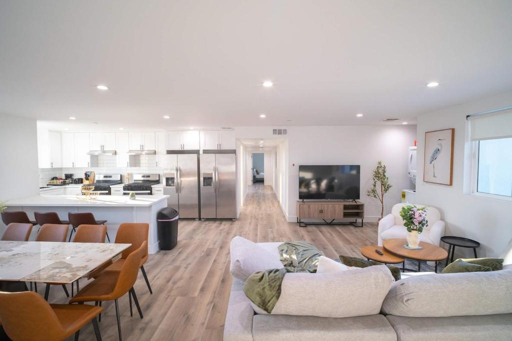 Una sala de estar con un sofá y una mesa y una cocina. en The Command Suite Urban Comfort Near USC, en Los Ángeles