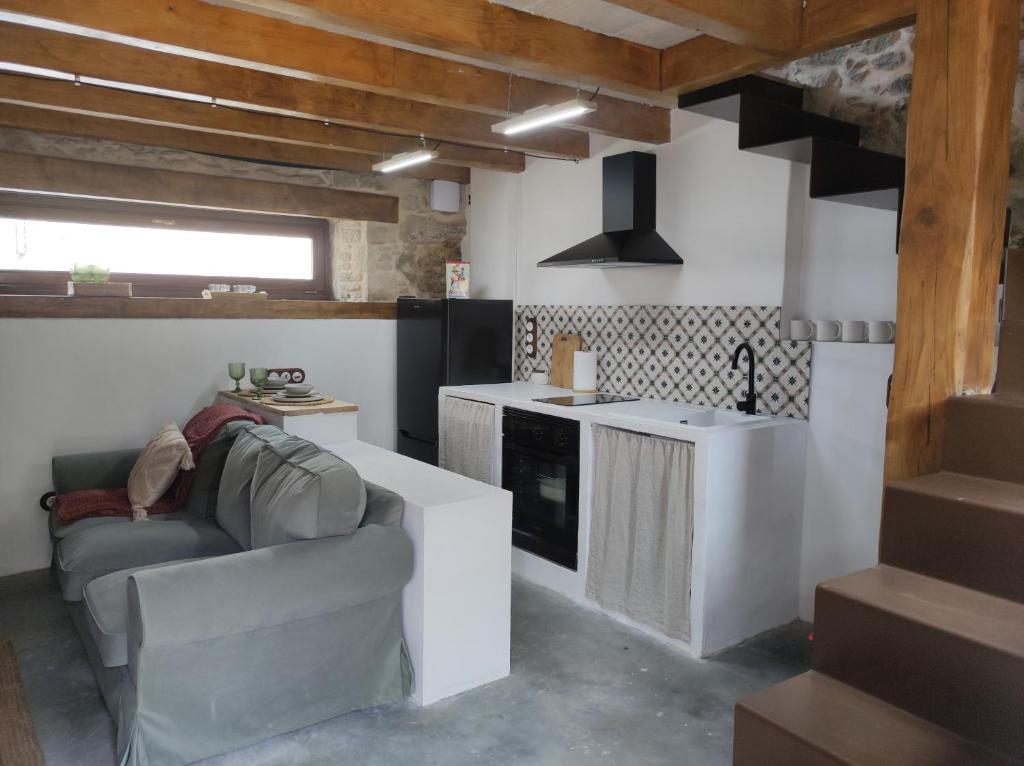 a living room with a couch and a kitchen at CasaManuela in Porto do Son