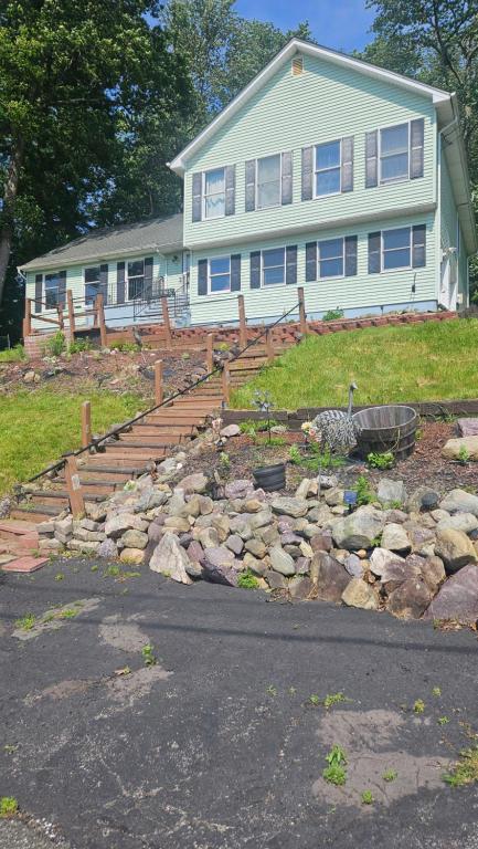 a house with a bunch of rocks in front of it at Mountain View Villa with HotTub-MovieTheater Fire Pit Gameroom in West Milford