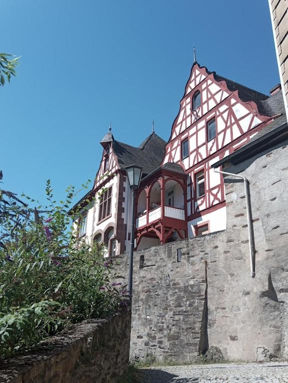 a large house on top of a stone wall at Das Alte Pastorat in Klotten