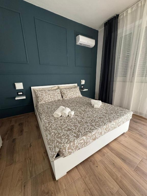 a bedroom with a bed with shoes on it at Casa Camurria in Aci Castello