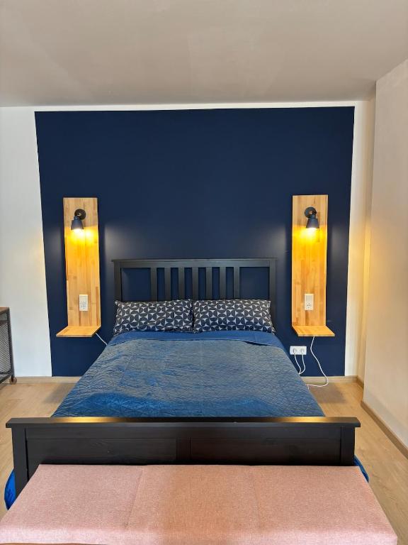 a bedroom with a bed with a blue wall at Indigo Apartment in Kassel