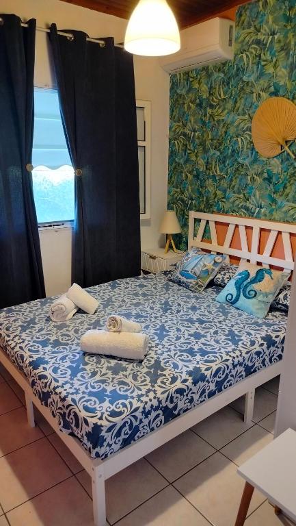 a bedroom with a bed with a blue and white comforter at Casa Nonna Traditional guest house in Oziás