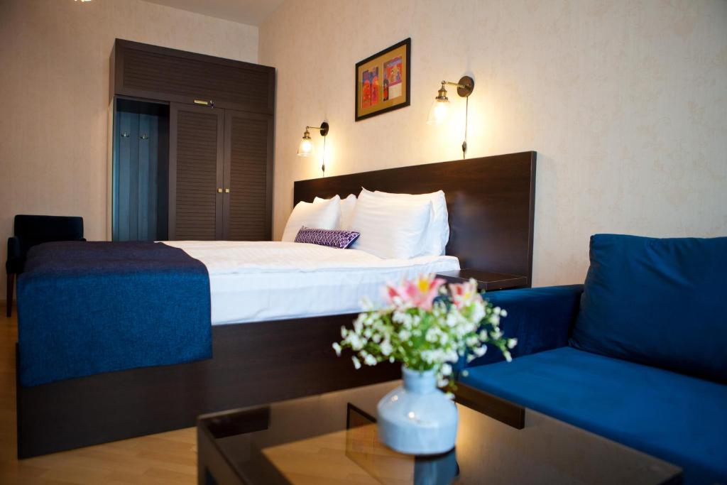 ein Hotelzimmer mit einem Bett und einem Sofa in der Unterkunft Hotel Bella Casa in Tbilisi City