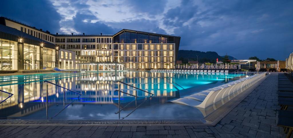 a large swimming pool in front of a building at RIKKA KHUST thermal resort in Khust