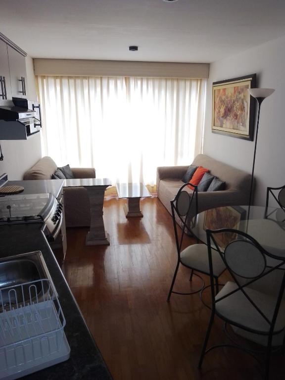 a living room with a couch and a table at Miraflores, Lima, apartamento 2 dormitorios in Lima