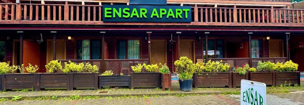 a building with a bunch of plants in front of it at Ensar Apart in Uzungöl