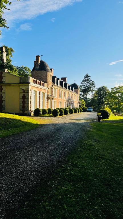 a large house with a road in front of it at L'Écrin du Marquis 
