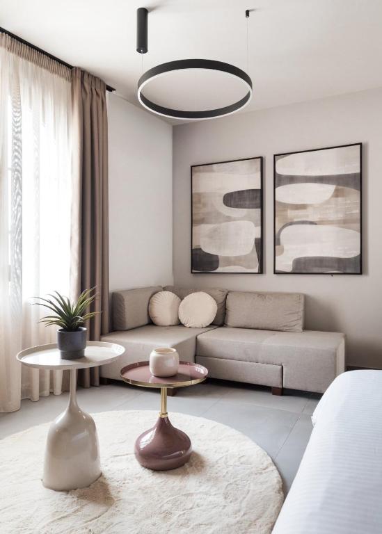 a living room with a couch and a table at Reve Suites Ioannina in Ioannina