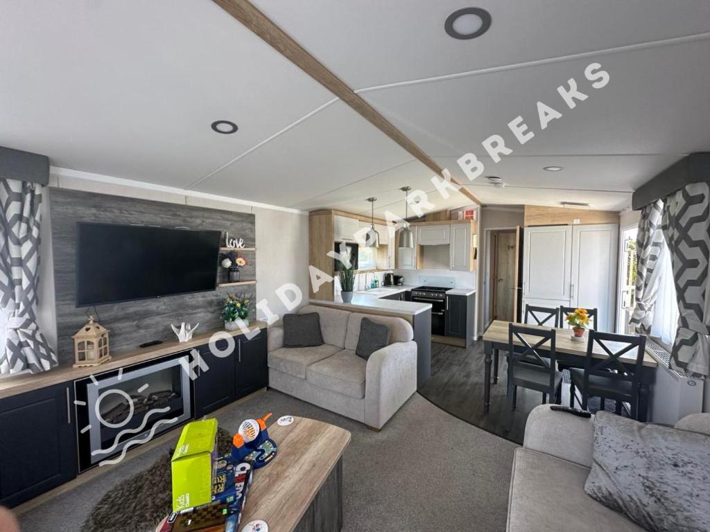 a living room with a couch and a table and a kitchen at Coopers Corner - Stylish 2 bedroom home, Seal Bay - Pets Welcome in Selsey