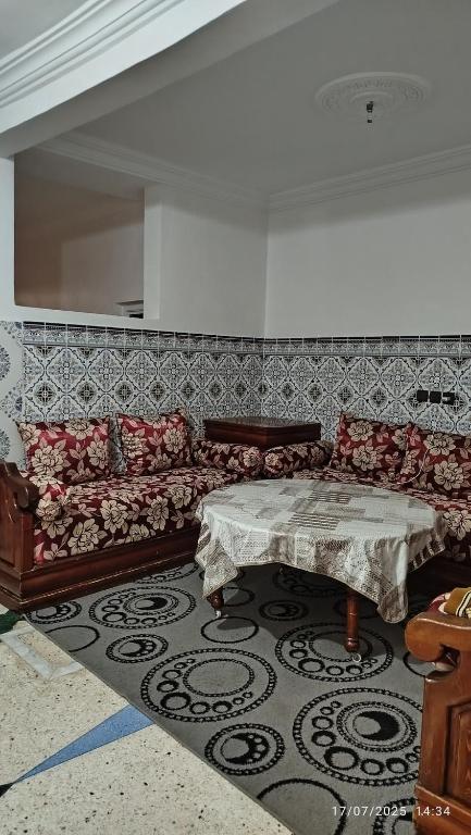a living room with a couch and a table at Peaceful family apartment in Agadir
