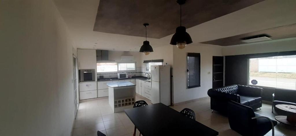 a kitchen and living room with a couch and a table at La paz in Médanos