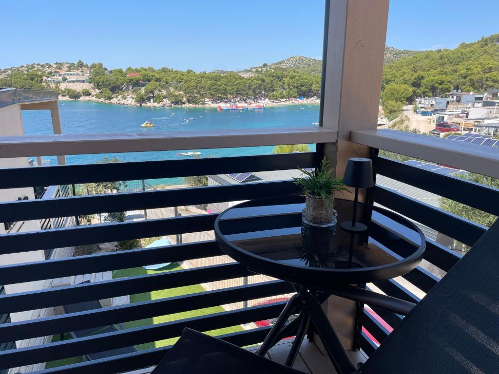 a balcony with a table and a view of the water at SeaHouse in Drage