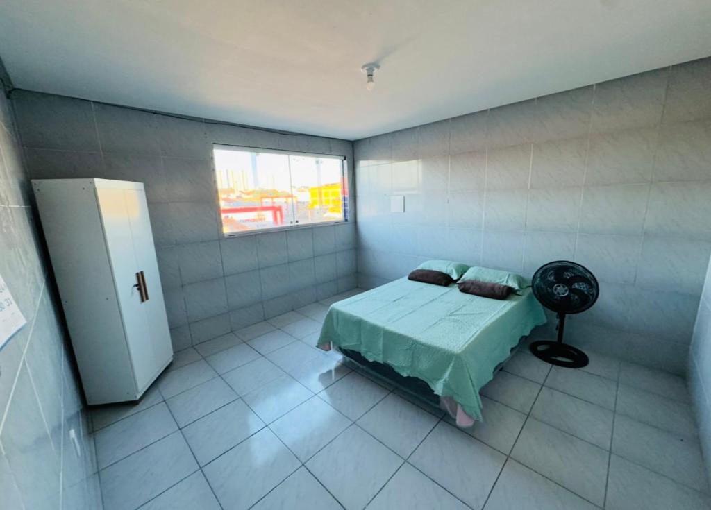 a bedroom with a bed and a window in it at Apê 200 in Caruaru