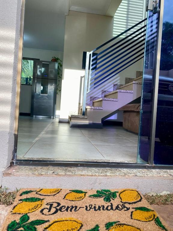 a welcome mat in front of a building with a door at Casa em Bonito in Bonito